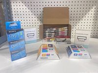 Group shot of all items: boxed Sony DVC tapes, HP ink cartridges, portable mini printers, and open box of Kingjet cartridges