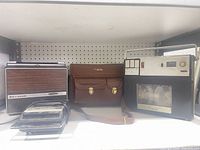 Group shot of projector, bag, reel-to-reel, cassette recorder