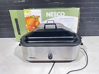 Front view of Nesco roaster oven with box