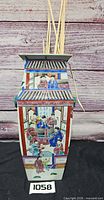 Front view of square tapered porcelain vase with painted figures and calligraphy