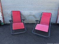 Both red zero-gravity chairs front view folded open