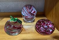 All three paperweights on shelf