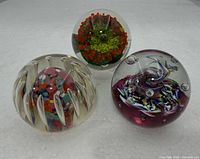 All three paperweights side by side