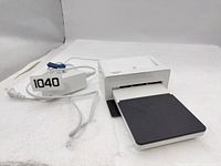 Front and side view of printer with power adapter and cable