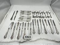 Full layout of 38-piece silver-plate flatware set