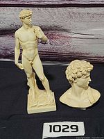 Full view of both resin David pieces on black backdrop