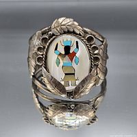 Front view showing entire cuff bracelet with inlay figure and leaf motif