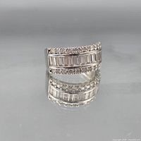 Front view of sterling silver CZ band ring showing baguette and round stones
