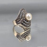Front view of sterling silver ring with pearl and marcasite accents