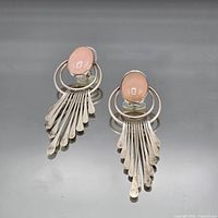 full view of both earrings showing design and stones