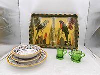 Group shot showing pasta bowl, two plates, green glass creamer & sugar, framed bird tray