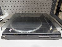 Technics SL-QD33 turntable with closed dust cover on shelf