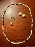 Full view of necklace, both earring pairs displayed