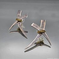 Full view of both X-shaped sterling earrings with brass accent and push backs