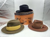 Front view showing three hats and Stetson box
