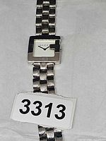 Front view of Gucci square stainless steel watch showing dial and bracelet