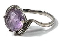 Top view of white gold ring showing oval lavender amethyst and pavé shoulders