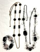 Overview of two necklaces and bracelet on white background