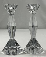 Full view of both crystal candlesticks standing upright