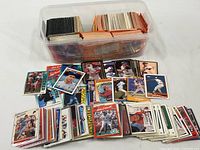 Overall view of bin with stacks of baseball cards and loose cards spread out