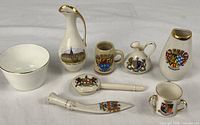 Group shot of all eight ceramic souvenir pieces