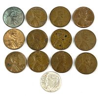 Group shot of 12 pennies and one dime