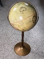 Full view of globe on pedestal showing stand and globe