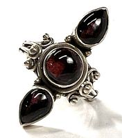 front view showing three garnet cabochons and ornate sterling setting