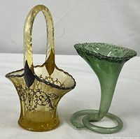 Yellow basket and green cornucopia vase side by side