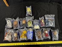 Overview shot of 16 sealed Burger King 2005 Star Wars toys