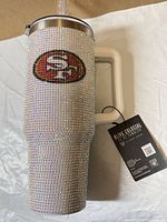 Full view of rhinestone-covered 49ers tumbler with tag attached