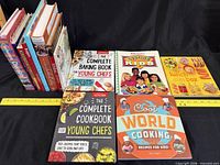 Overview of all cookbooks upright and laid flat