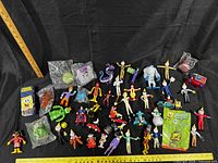 Overview of all toys laid out with rulers for scale