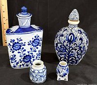 Four blue and white ceramic containers grouped together
