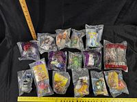 All sealed Burger King toys displayed with rulers for scale