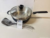 Pan with lid, steamer insert, sealed slotted turner