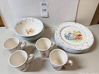 Full set showing four mugs, four bowls, four plates