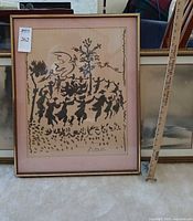 Front view of framed ink artwork showing dancing figures, mat, and frame