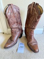 Full view of both boots upright showing overall condition and style