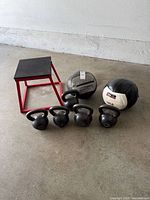 Group shot showing all kettlebells, both medicine balls and plyo box