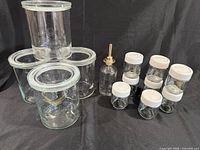 All items: four IKEA storage jars stacked, yogurt jars with white lids, oil bottle center