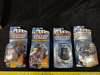 Front view of four sealed Justice League blister card figures
