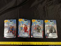 Front view of four Justice League Unlimited blister-carded figures: Superman, Flash, Green Lantern, Batman