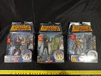 Front view of three sealed action figures on blister cards