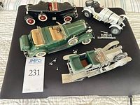 Top view of all four model cars and loose parts