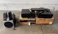 Group shot showing both receivers, subwoofer, satellites and accessories
