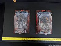 Front view of both blister-carded Samurai Skeletor and Man-at-Arms figures with ruler for scale
