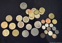 Group shot of all coins on black backdrop