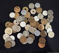 Full spread of mixed Japanese Yen coins on black background
