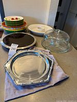 Full lot showing dinnerware stack, serving tray, marble platter, glass cloche